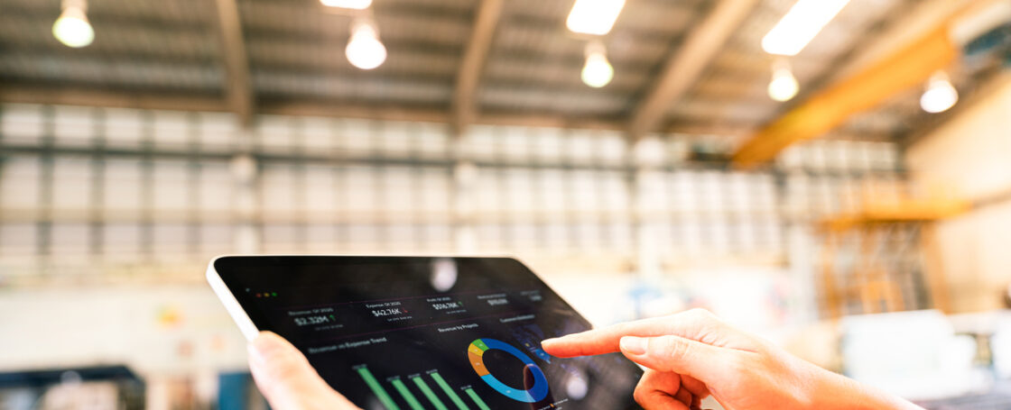 A worker is using tablet to review storage report - Business management and technology concept photo.